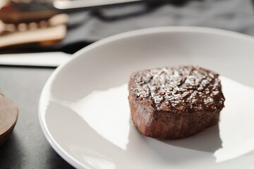 Whole beef steak on white plate
