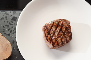 Whole beef steak on white plate