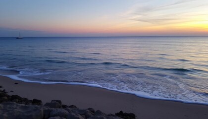 Serene sunset over calm ocean beach; distant sailboat; peaceful coastal scene; perfect for travel brochures