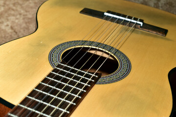 Obraz premium Pictured is an acoustic six-string guitar with a wooden neck.