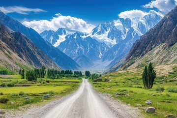 Fototapeta premium Scenic mountain road leads to majestic peaks. Ideal for travel, adventure, and nature themes.