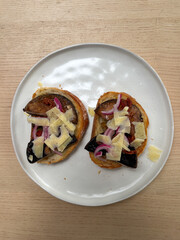 A plate of toast with mushroom and cheese.