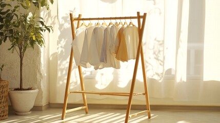 A wooden clothes drying rack with freshly washed clothes hanging, set against a bright, airy backdrop with natural sunlight streaming through the window