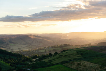 Expansive landscape view at sunset across rolling hills in a rural area