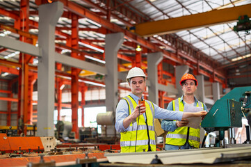Engineer working team service and discussing plan of maintenance machine in heavy industrial factory