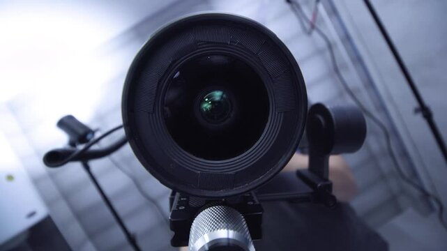 Real estate photographer videographer. Lens reflection on a bathroom mirror. Camera equipment on a stabilizer gimbal.
