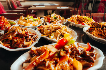 Variety of Asian Cuisine Dishes with Noodles, Stir-Fry, and Sweet and Sour Plates