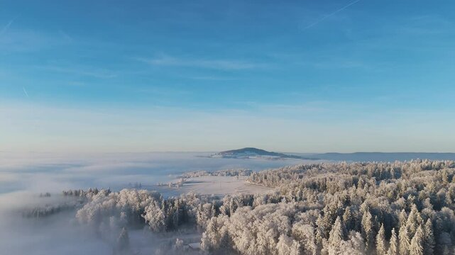 Aerial view over dreamy winter landscape (Switzerland) with sea of clouds