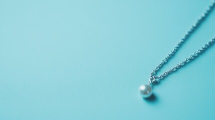Fototapeta premium Minimalist silver jewelry on a powder blue background, creating a soft and elegant vibe.