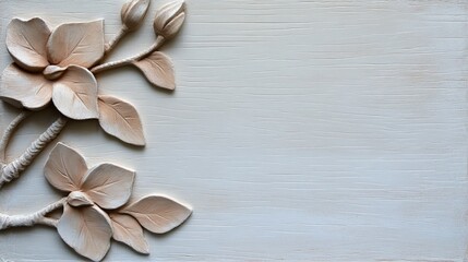 Elegant beige floral relief on a light gray wood background.  Perfect for invitations, announcements, or home decor.