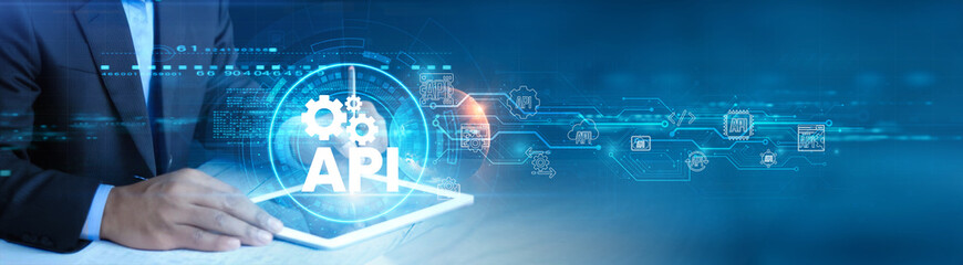API. Businessman holding and using a digital tablet device with innovative technology solutions, digital transformation, modern business strategy concept.