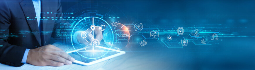 Businessman holding and using a digital tablet device with Industry 4.0 technologies, cyber-physical systems, IoT integration, smart automation, data analytics, artificial intelligence concept.
