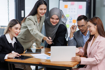 Happy asian business woman executive ceo leader discussing project management planning strategy working with diverse colleagues company team at office corporate board group meeting.
