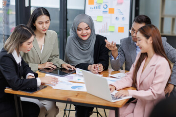 Happy asian business woman executive ceo leader discussing project management planning strategy working with diverse colleagues company team at office corporate board group meeting.
