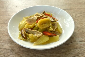 stir fried pickled cabbage with slice pork stomach and chili on plate 