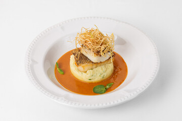 Fine cuisine on a white plate on a white background. Author's cuisine