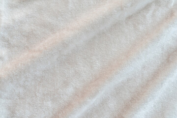 Beige velvet cloth background or ivory cream color suede velour flannel texture made of cotton or wool with soft fluffy velvety satin fabric metallic color material