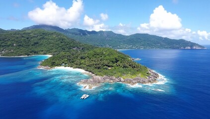 Aerial view of a lush tropical island surrounded by clear blue waters.