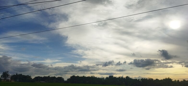cloudy silver sky over the field before sunset
