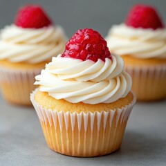 Delightful raspberry-topped cupcakes showcase creamy frosting and sweetness