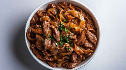 Beef stir-fry served with wide noodles in a white bowl