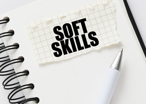 SOFT SKILLS on a piece of paper placed on the notebook. Concept for business.