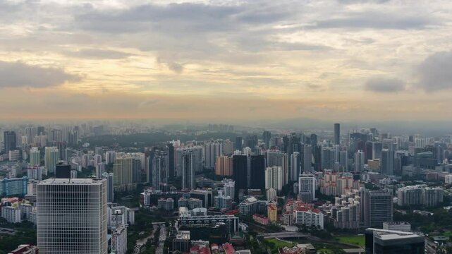 aerial timelapse landscpe view of Singapore city skyline in sunset time with many highrise skyscrapper office and housing building
