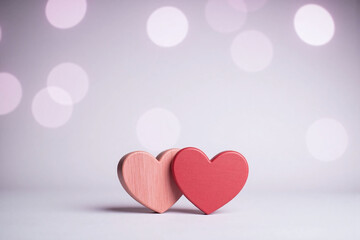 two heart shaped wooden decorations light gray surface bokeh