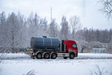 water truck sprays water in winter and makes a skating rink in the yard
