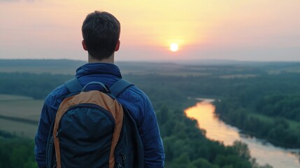 Fototapeta premium Man with backpack watching sunset from mountain top nature landscape