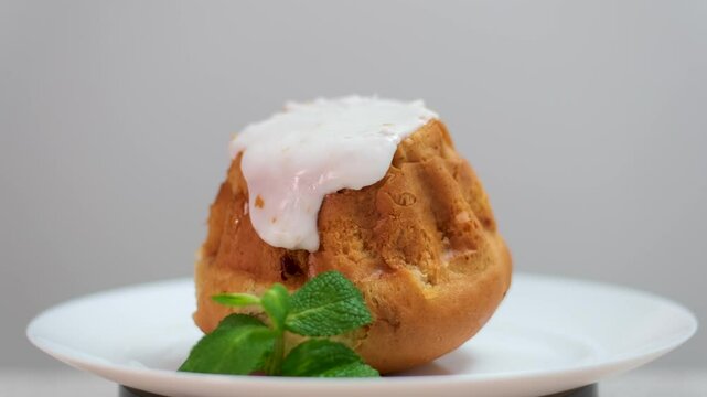 Ring rum baba with lime and basil isolated on the white background. Cake cross section