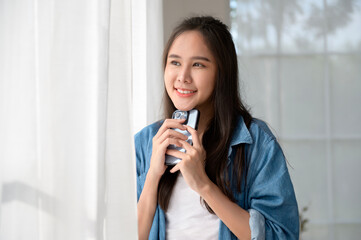 Young Asian woman enjoy using smartphone at home