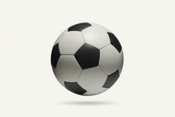 Naklejka premium A classic black and white soccer ball floats against a plain white background.