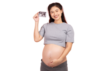 Pregnant woman smiling while holding ultrasound photo, expressing joy and excitement