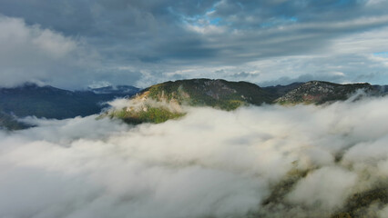 Aerial view of clouds and mountains at sunrise
