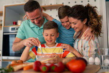 Cheerful Modern Family Preparing Healthy Fresh Ingredients in Bright Kitchen Space