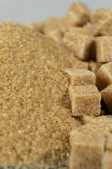 Brown cane unrefined demerara sugar in the form of crystals and cubes