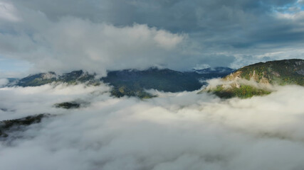 Aerial view of clouds and mountains at sunrise