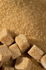 Brown cane unrefined demerara sugar in the form of crystals and cubes