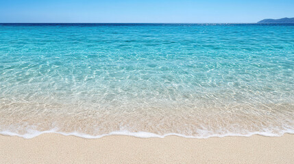 Fototapeta premium Crystal clear turquoise water meets sandy beach under bright sky