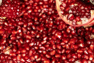 Pomegranate background, lots of peeled pomegranates and seeds