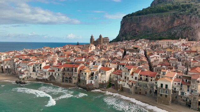Aerial view of Coastal village of Cefalu shines with historic charm and scenic beauty under a bright sky. Sicily. Italy