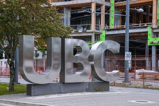 Vancouver, CANADA - Sep 30 2024 : Iconic UBC (The University of British Columbia) sign located in front of a construction site, surrounded by trees and urban infrastructure on the university campus.