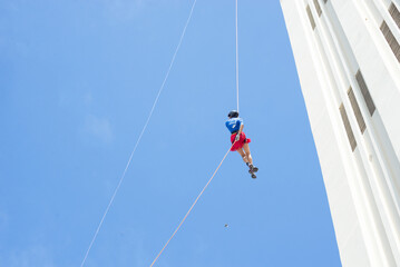 Young athlete is seen rappelling down the Elevador Lacerda in the city of Salvador, Bahia.