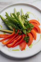 Sliced tomatoes, cucumbers, peppers, and fresh herbs are beautifully arranged on a white plate, creating a vibrant and healthy appetizer or side dish. Restaurant or cafe menu, cookbook recipe