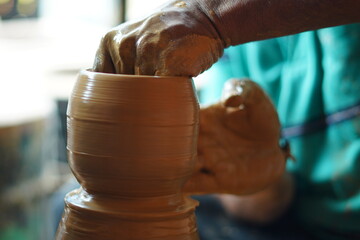 Potters hand making cup