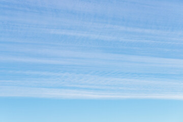 Long thin streaks of clouds in the blue sky