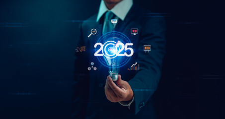 Business goal and vision for 2025. Performance target for success Concept, businessman holding light bulb with text 2025 for business start-up. Strategy and process for annual business plan