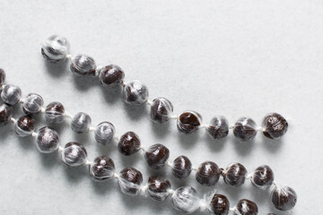 Overhead view of nigerian baba dudu candy on white background, top view of Ghana coconut candy or kube toffee candy, hard candy made with coconut milk and sugar on granite countertop