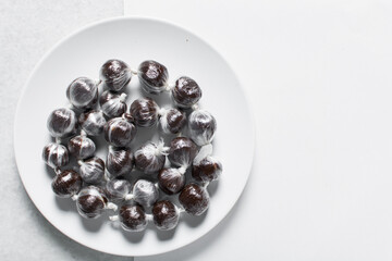 Overhead view of nigerian baba dudu candy, top view of Ghana coconut candy or kube toffee candy, hard candy made with coconut milk and sugar